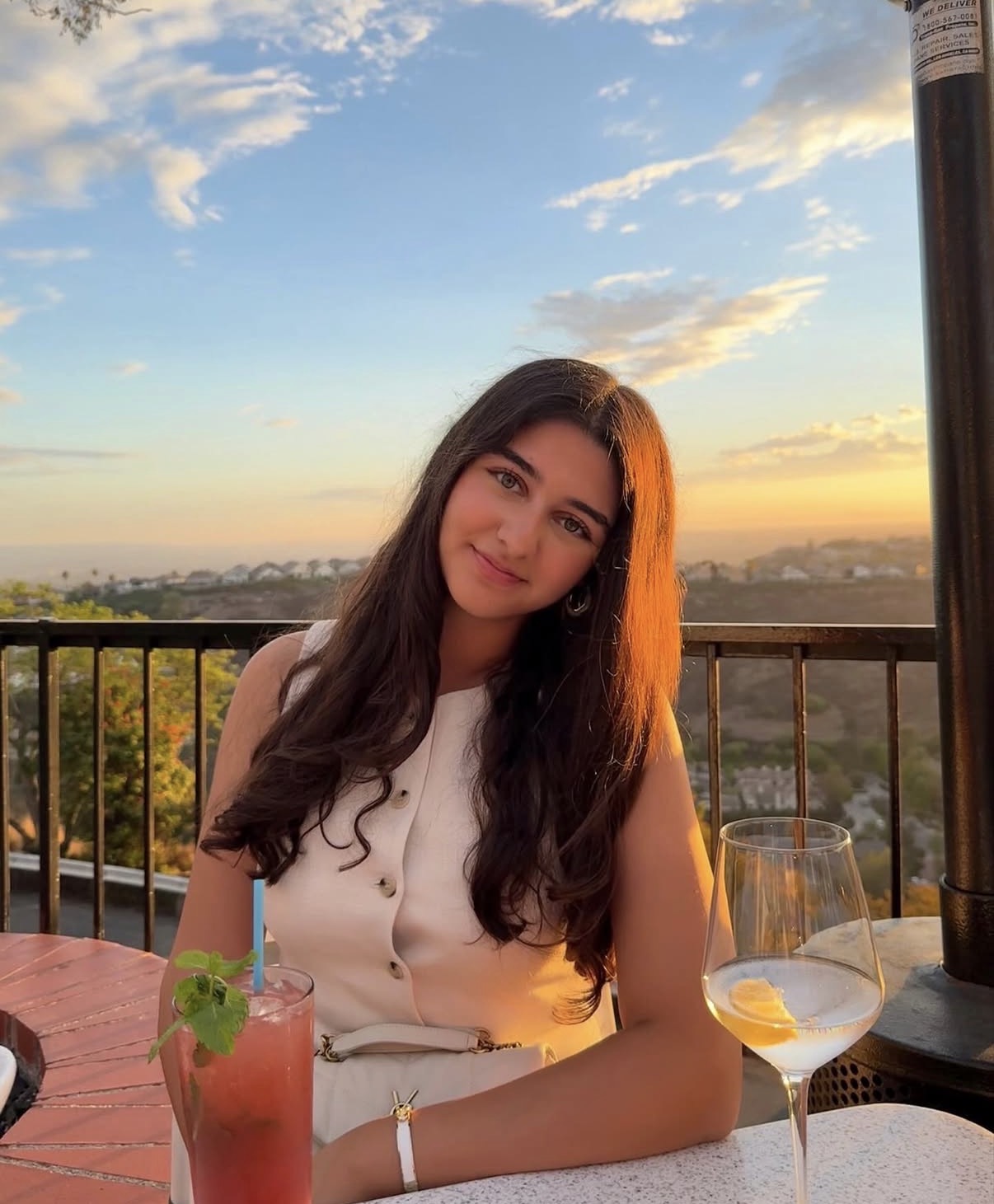 Fidan Aliyeva, founder of She's Business, smiling outdoors at sunset